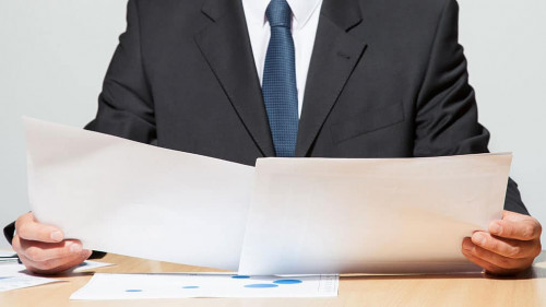 Businessman comparing two documents