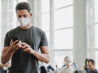 Men with respirator mask in airport. Covid-19 and Air pollution concept.