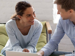 Male manager and female office worker having fun at work