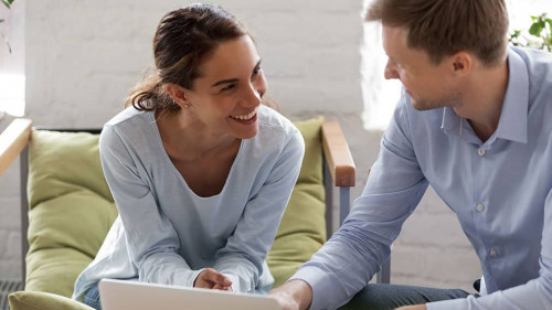 Male manager and female office worker having fun at work