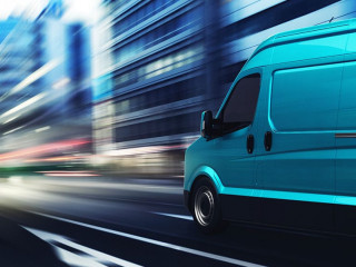 Transportation service with a cyan van moving fast on the road