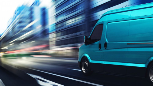 Transportation service with a cyan van moving fast on the road