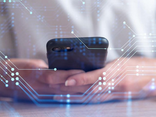 Businesswoman in formal wear holding in the hands a smart phone and testing an innovative application to provide a completely new service. Close up shot. Hologram tech graphs. Concept of Dev team.