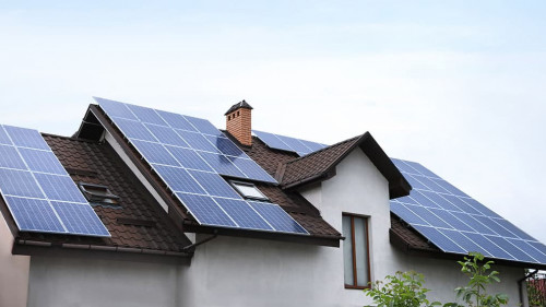 House with installed solar panels on roof. Alternative energy so