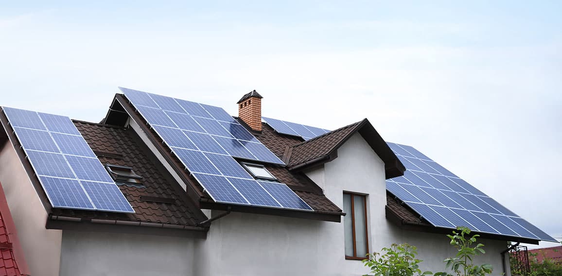 House with installed solar panels on roof. Alternative energy so