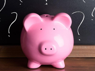 Piggy Bank With Question Mark On Black Board