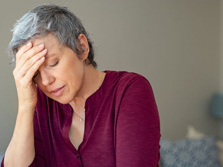 Stressed senior woman at home