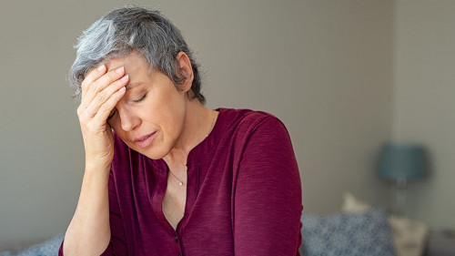 Stressed senior woman at home