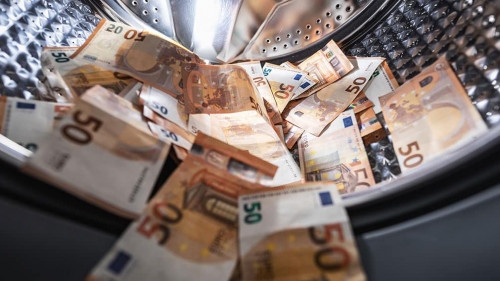money laundering concept - euro banknotes in washing mashine