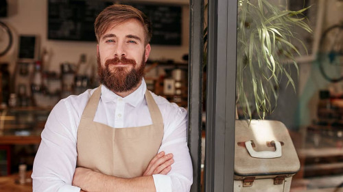 Handsome and confident cafe owner