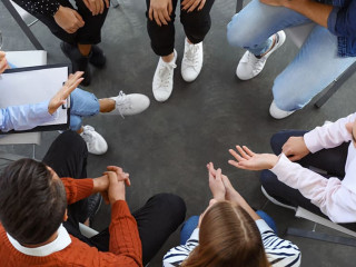 Psychotherapist working with patients in group therapy session,