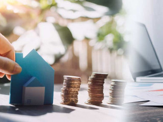 stacking dollars coins with a house model.save and investment fo