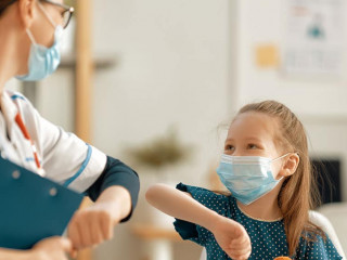 Doctor and child wearing facemasks