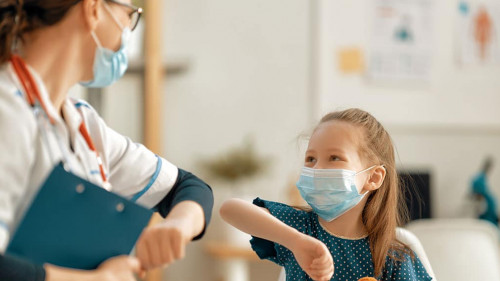 Doctor and child wearing facemasks