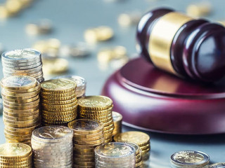 Towers with euro coins and justice hammer in the background