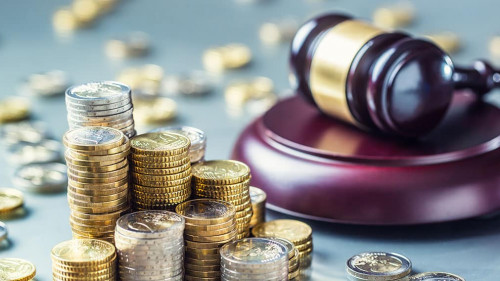 Towers with euro coins and justice hammer in the background