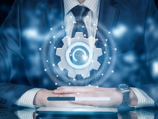 A closeup of a businessman sitting with the update sign system in front of him.