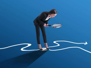 Young european businesswoman with magnifier and arrows on blue background. Success, leadership, choice and direction concept.