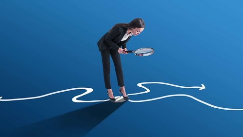Young european businesswoman with magnifier and arrows on blue background. Success, leadership, choice and direction concept.
