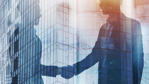 Handshaking business person in office. concept of teamwork and partnership. double exposure