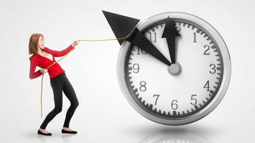 Woman pulling clock hands backwards