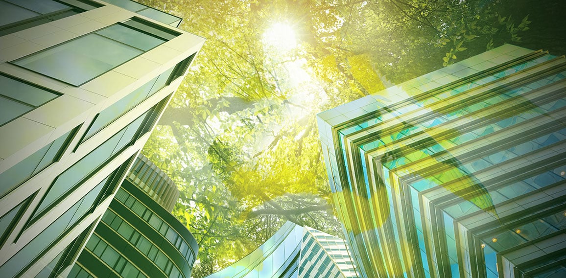 Go green concept. Low angle view of modern building and trees on