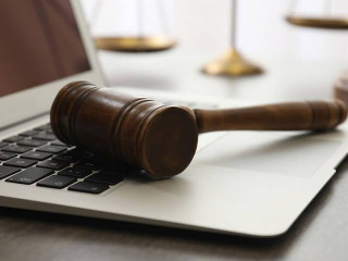 Laptop, gavel and scales on table, closeup. Cyber crime