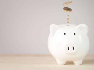 Coins falling and dropping to white piggy bank saving ,money sav