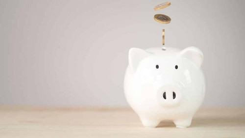 Coins falling and dropping to white piggy bank saving ,money sav