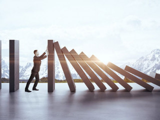 Businessman in suit pushing blocks