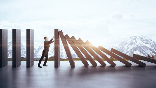 Businessman in suit pushing blocks