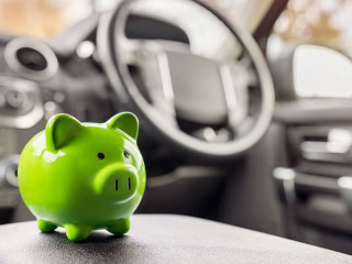 Green piggy bank money box inside car, vehicle purchase, insuran