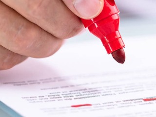 Businessperson Holding Marker On Document