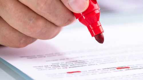 Businessperson Holding Marker On Document