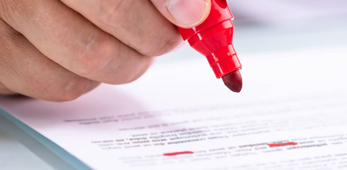 Businessperson Holding Marker On Document