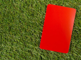 Soccer sports referee red cards on grass background flat lay fro