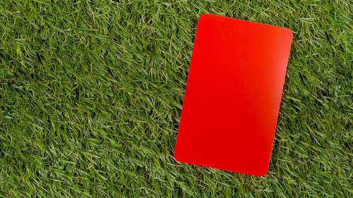 Soccer sports referee red cards on grass background flat lay fro