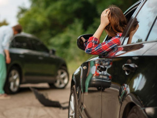 Male and female drivers after car accident on road
