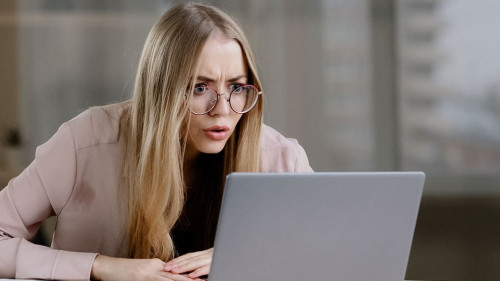 Shocked caucasian millennial business woman female student worker user receiving bad news message low grade test failed exams losing computer bet feeling shock lost fear horror looking at laptop