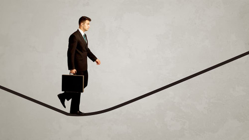 Salesman walking on rope in grey space