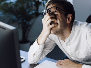 Panicked businessman having issues with his computer