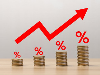 Pile of coins with red arrows showing percentages on the table. The Financial Crisis About Inflation. the concept of higher price inflation and more expensive food