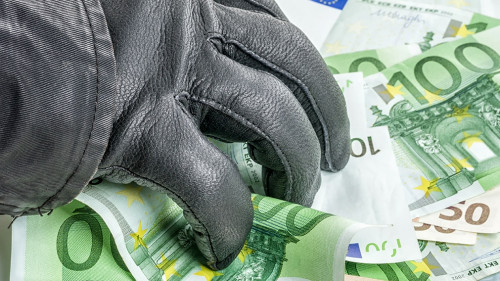 Dieb mit Lederhandschuh greift nach Geldscheinen