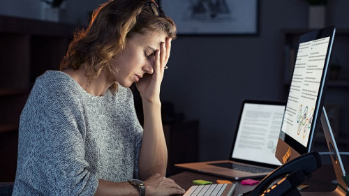 Stressed woman working over time at night