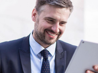 Happy businessperson with tablet