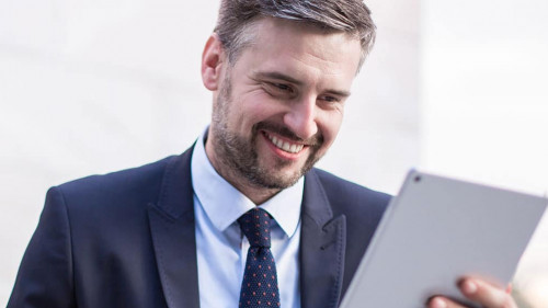 Happy businessperson with tablet