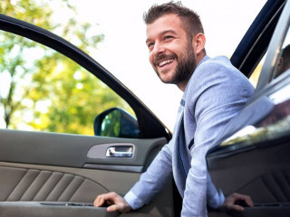 Smiling man exiting his vehicle