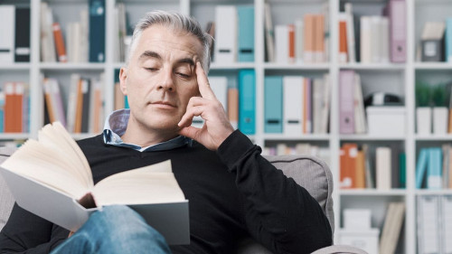 Man relaxing and reading a book