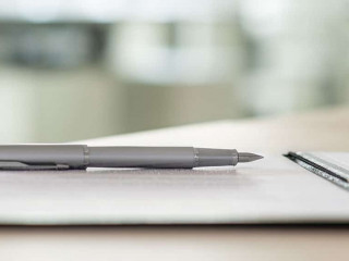 Ink pen lying on a contract