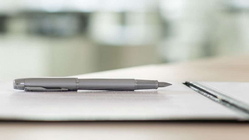 Ink pen lying on a contract